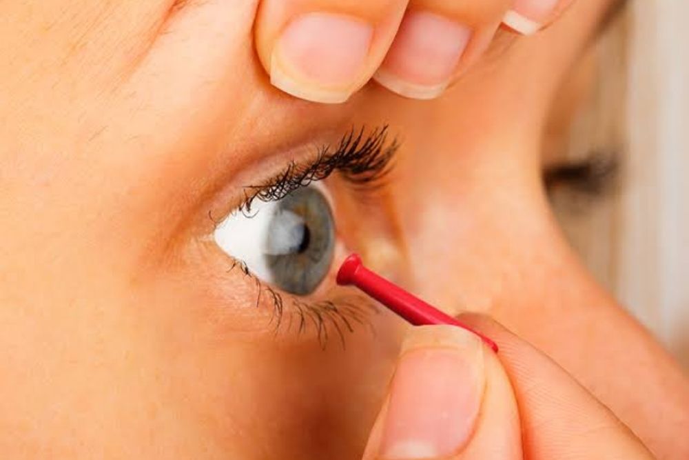 woman using a contact lens remover