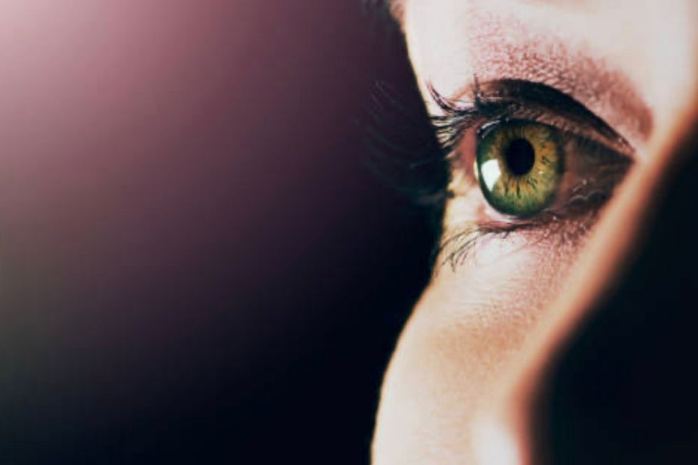 Why do humans have darker eyes with dark skins